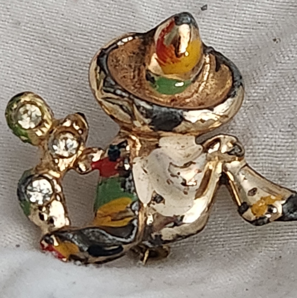 Vintage Sombrero resting with rhinestones and Enamel. Colorful Mexico, cactus